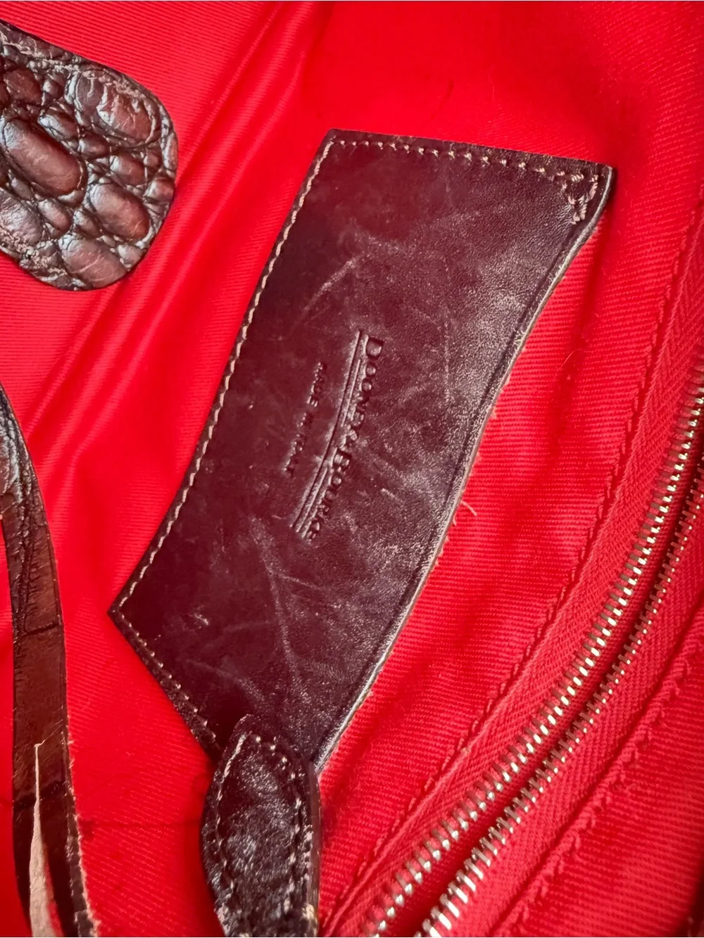 Dooney & Bourke, crafted from rich brown crocodile-embossed leather